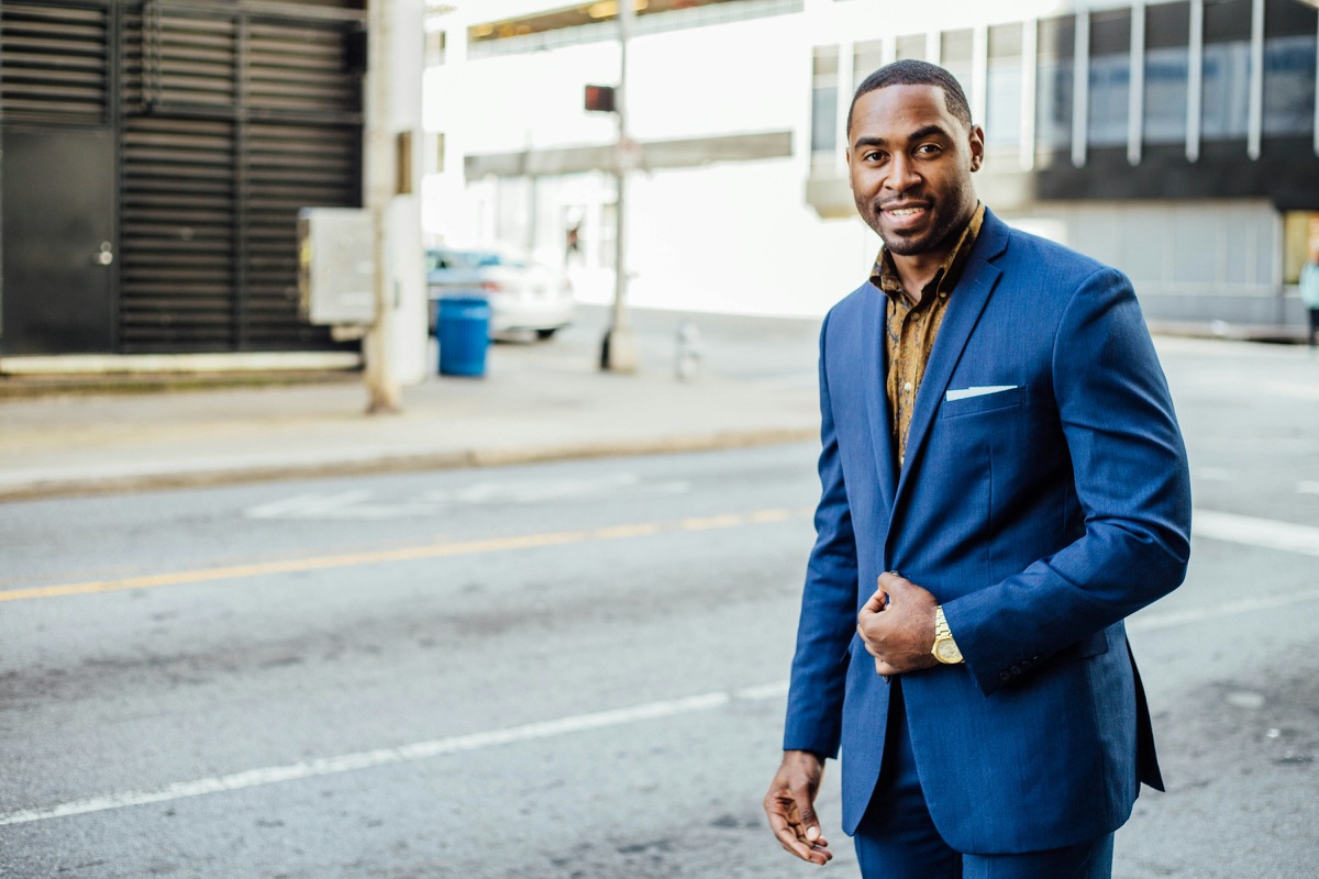 A professional in a blue suit on a city street